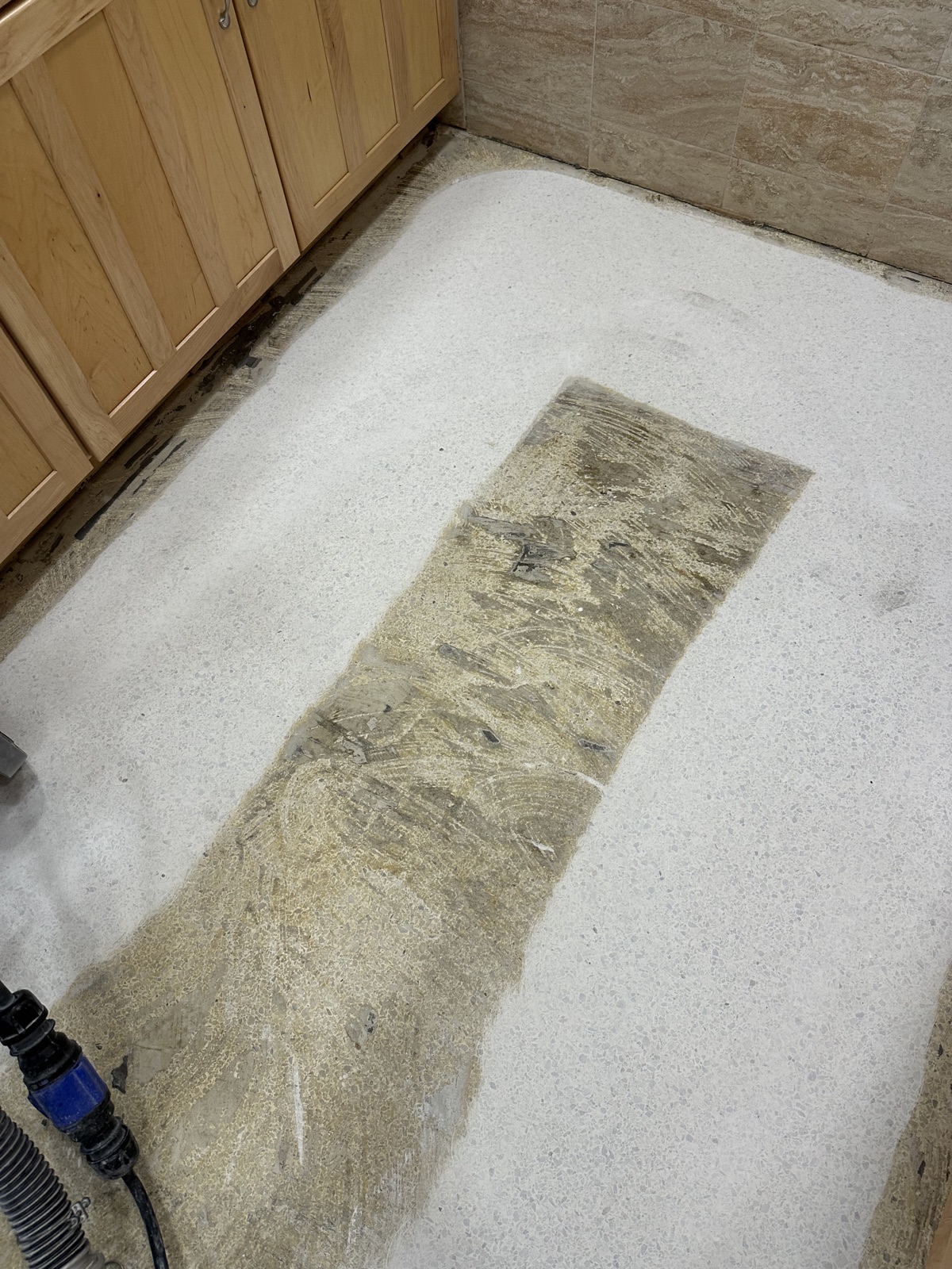 Grinding adhesive off terrazzo from vinyl flooring