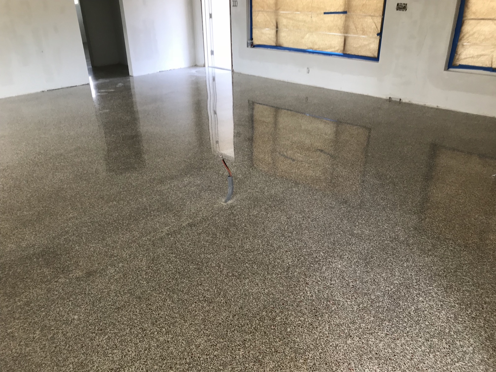 Polished terrazzo in a Southgate home with a patched trench visible