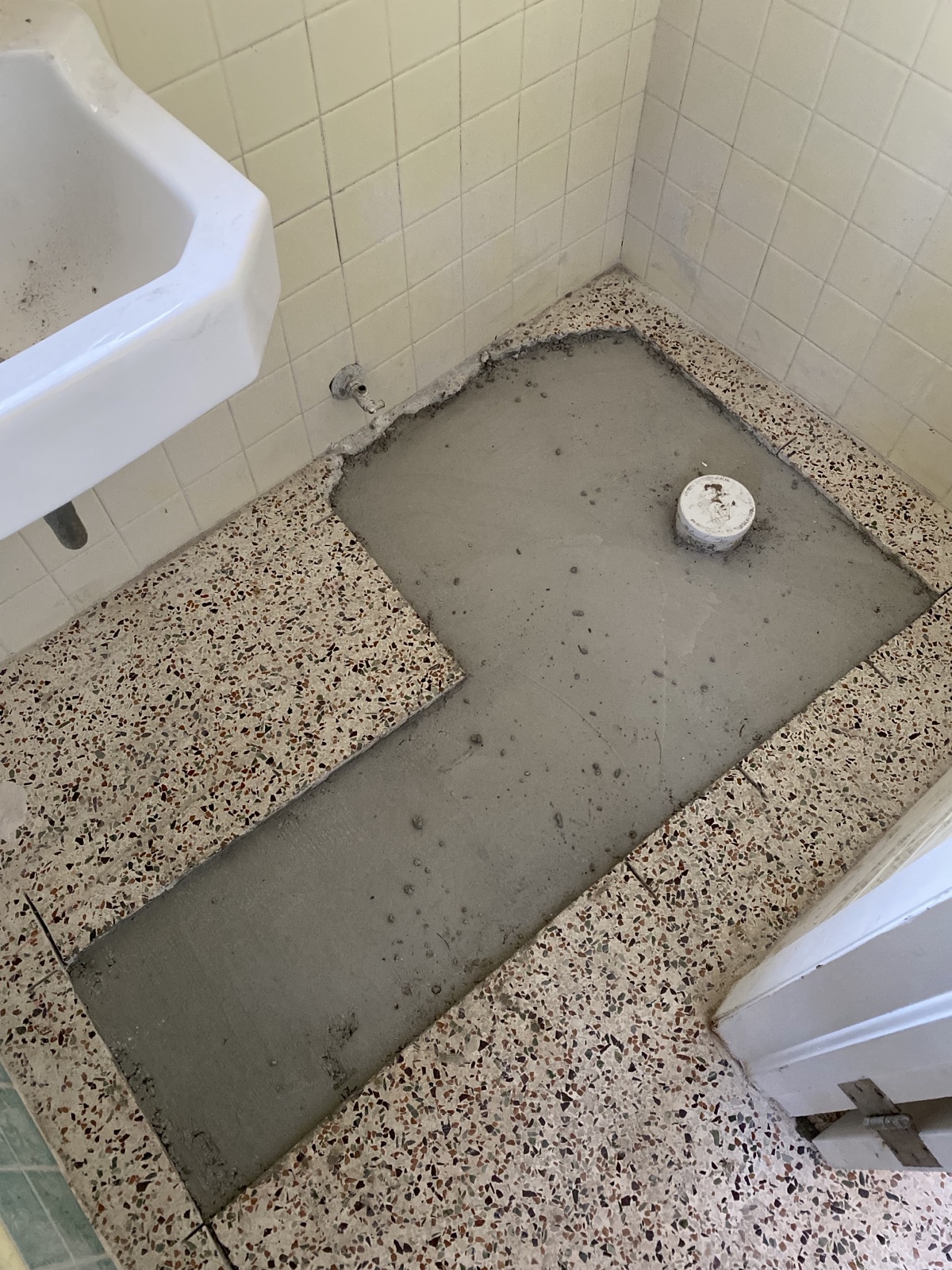 Large trench in bathroom before being patched